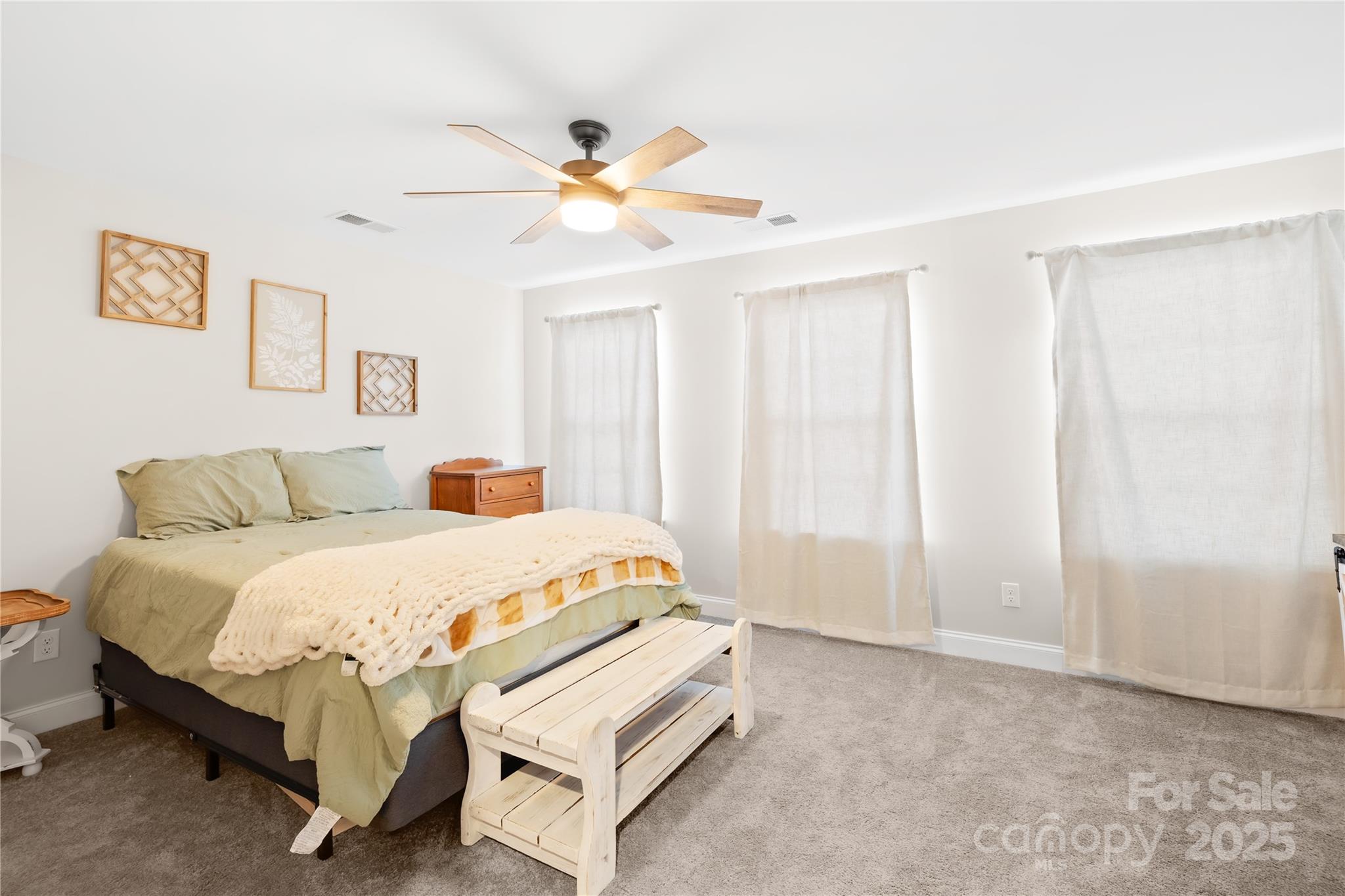5405 Austin Road Monroe, NC 28112 - Photo 22 of 38 a bedroom with a bed and a chandelier