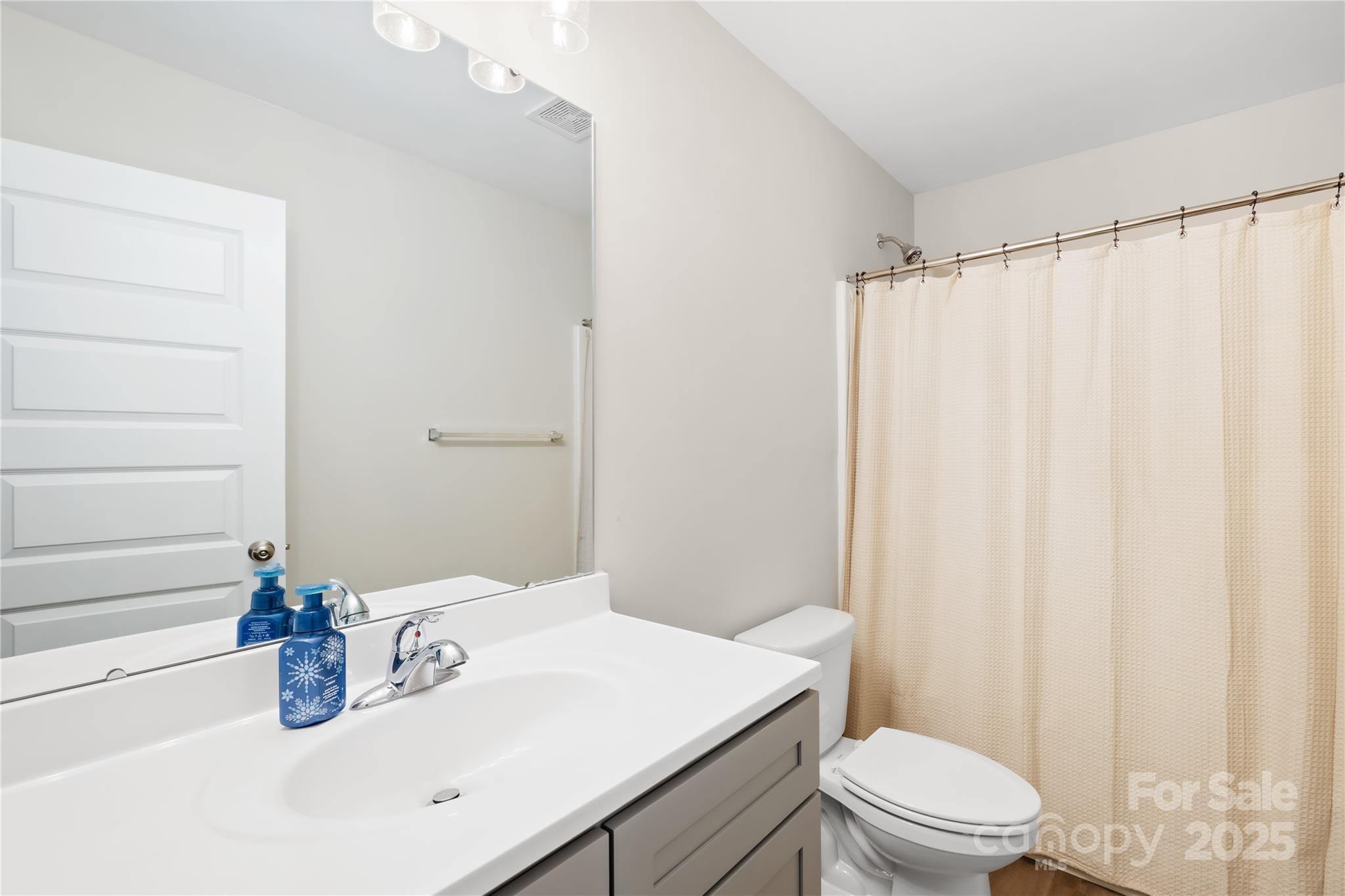 5405 Austin Road Monroe, NC 28112 - Photo 23 of 38 a bathroom with a sink a toilet and shower curtain