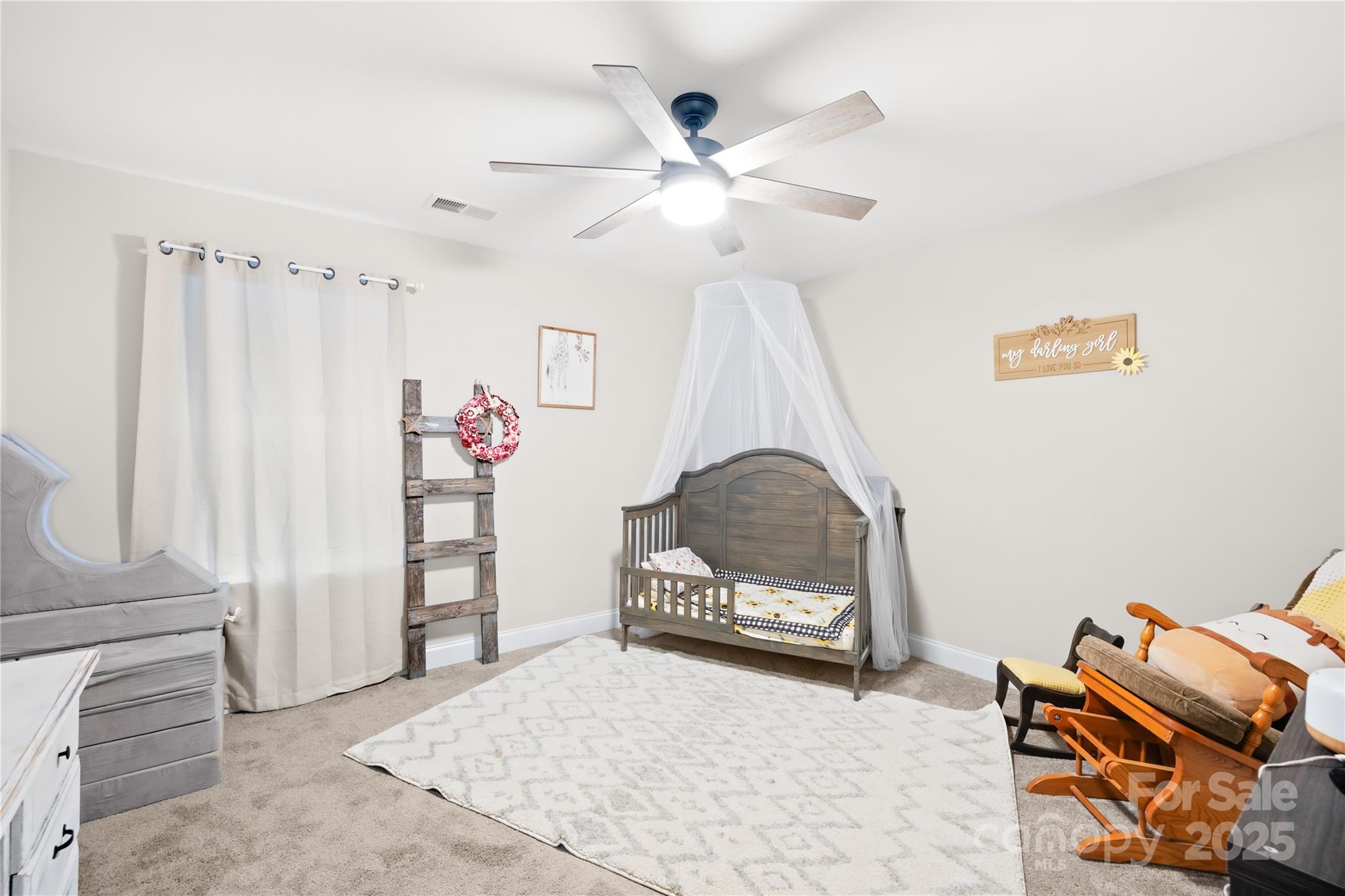 5405 Austin Road Monroe, NC 28112 - Photo 24 of 38 a living room with furniture and a baby crib