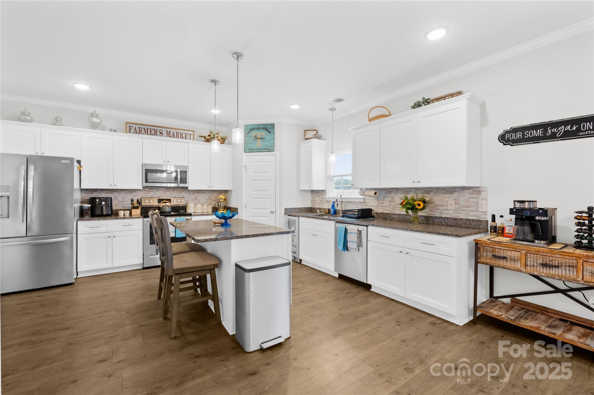 5405 Austin Road Monroe, NC 28112 - Photo 3 of 38 a kitchen with a sink a counter top space stainless steel appliances and cabinets