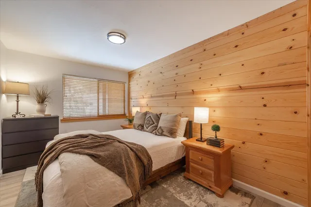 a bedroom with a bed and a night stand