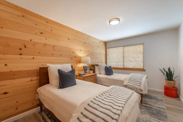 a bedroom with a bed and a potted plant