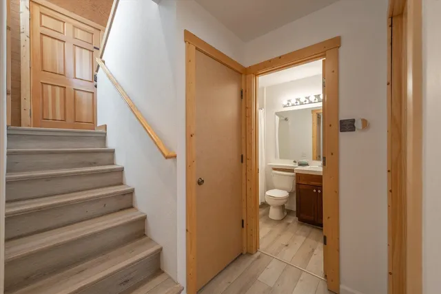 a view of a hallway with a livingroom and a bathroom