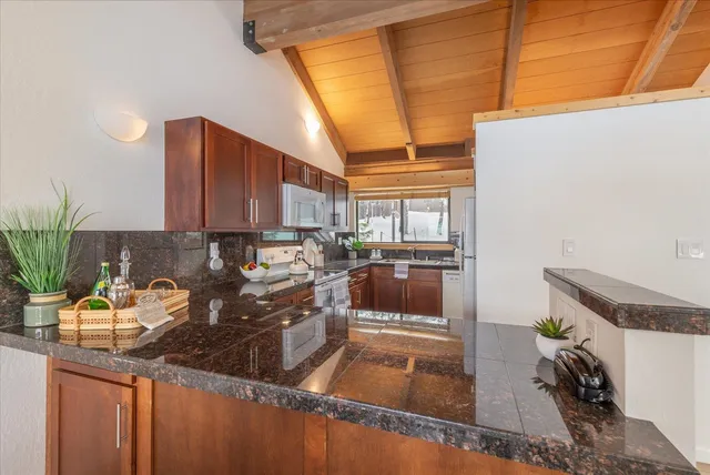a kitchen with a sink and a stove top oven