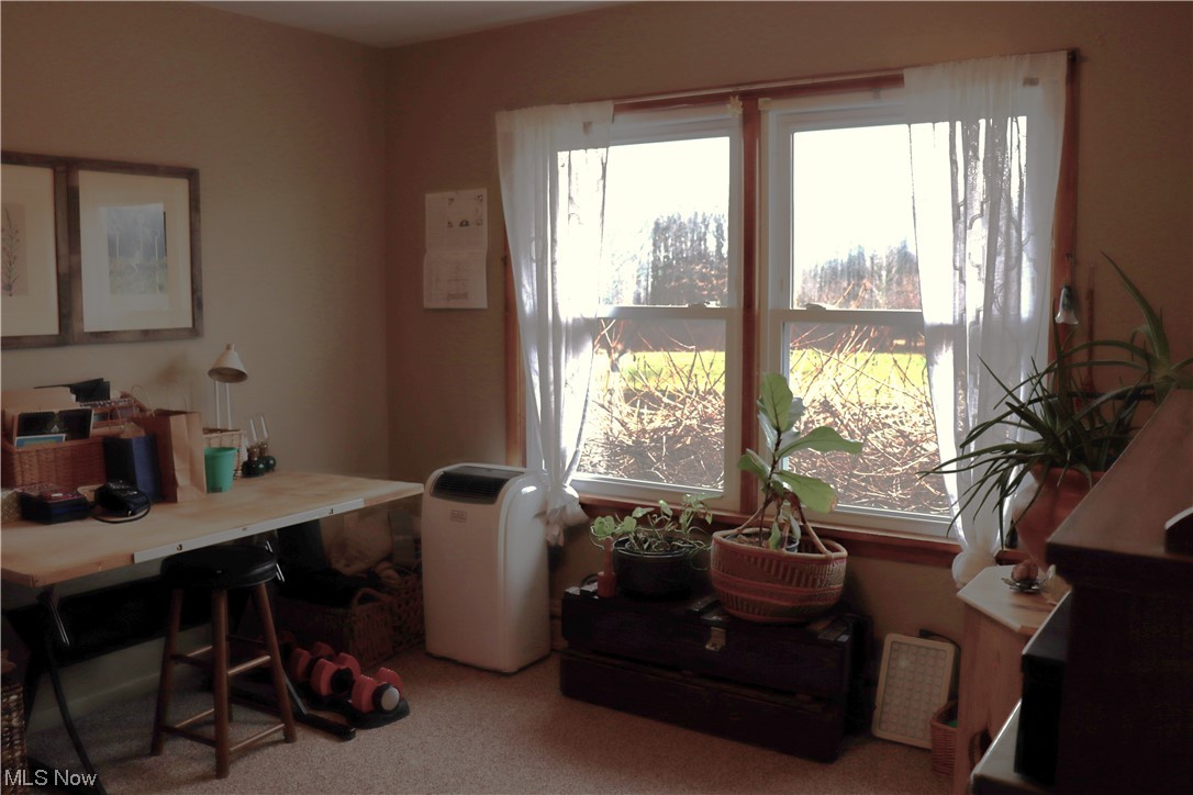 12099 County Line Road Chesterland, OH 44026 - Photo 25 of 35 2 of 2 bedrooms in 1st apartment. Currently used as an office. it also has a great view of the pond as well as the top of the pergola over the patio.