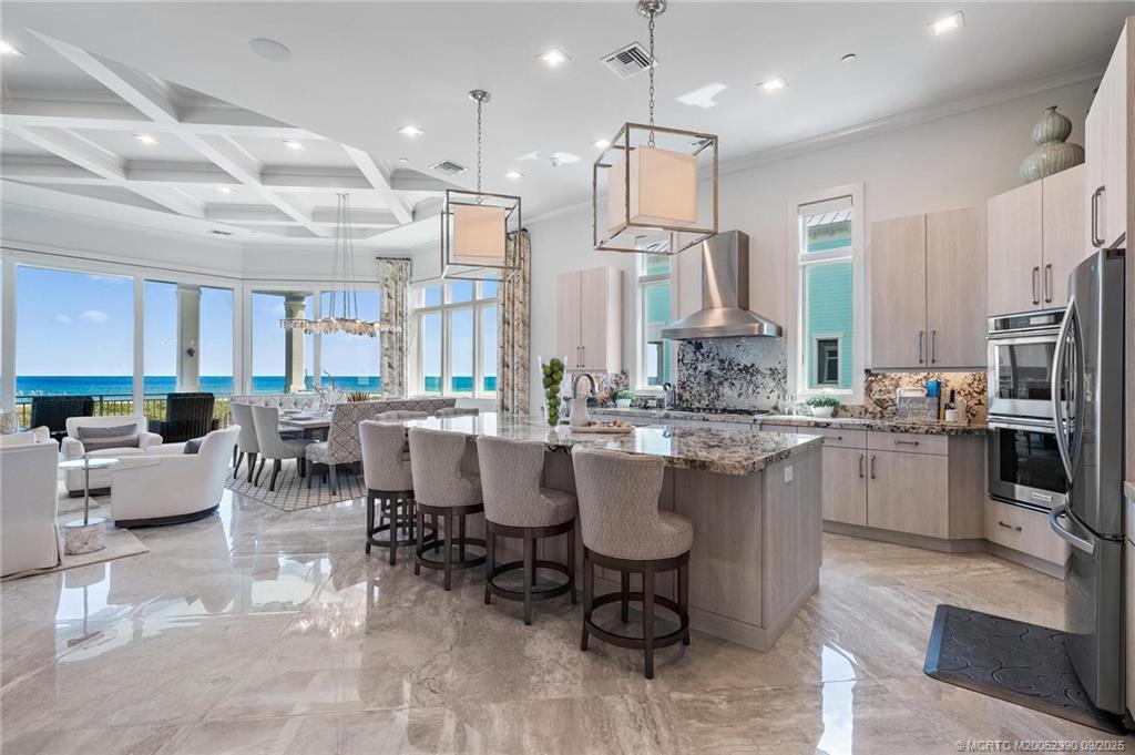 4860 Watersong Way Fort Pierce, FL 34949 - Photo 13 of 45 a large kitchen with a table and chairs