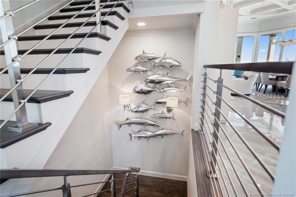 4860 Watersong Way Fort Pierce, FL 34949 - Photo 20 of 45 a view of a hallway with wooden floor and staircase