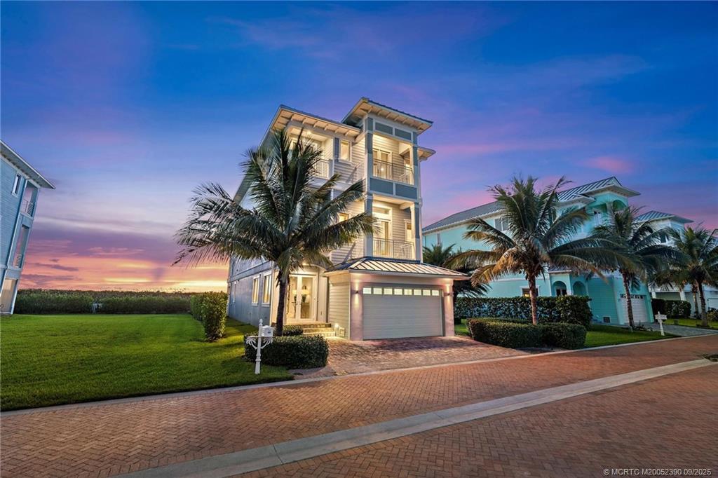 4860 Watersong Way Fort Pierce, FL 34949 - Photo 2 of 45 a palm tree sitting in front of a house with a yard