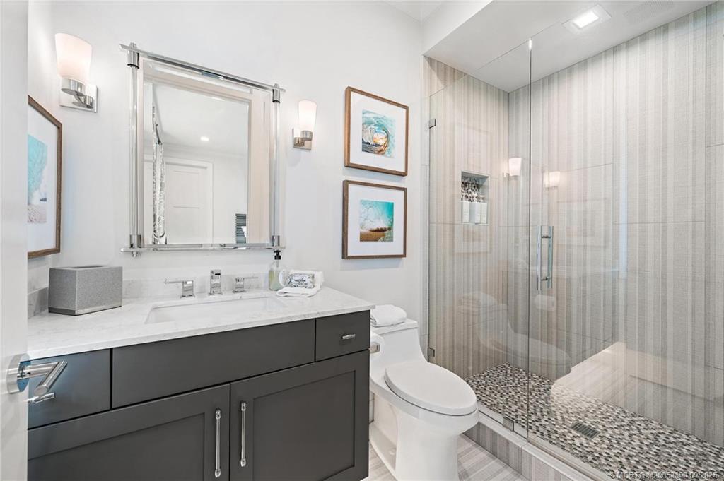 4860 Watersong Way Fort Pierce, FL 34949 - Photo 25 of 45 a bathroom with a sink a toilet and shower