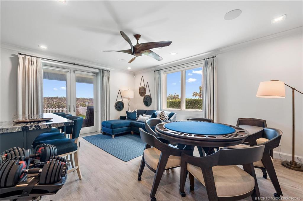 4860 Watersong Way Fort Pierce, FL 34949 - Photo 29 of 45 a living room with furniture a flat screen tv and a large window
