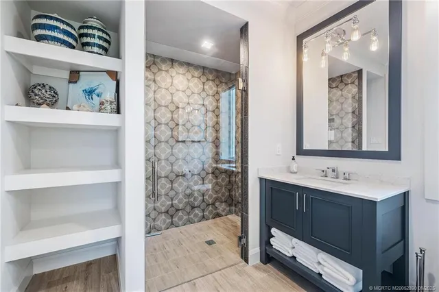 a bathroom with a sink a mirror and a shower