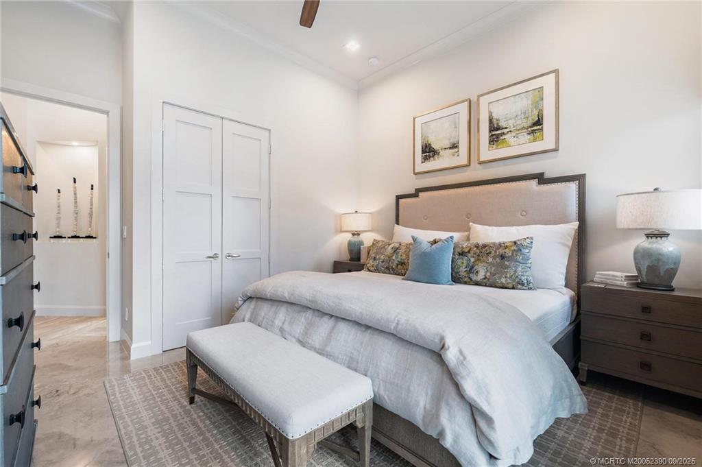 4860 Watersong Way Fort Pierce, FL 34949 - Photo 34 of 45 a bedroom with a bed and a lamp on dresser