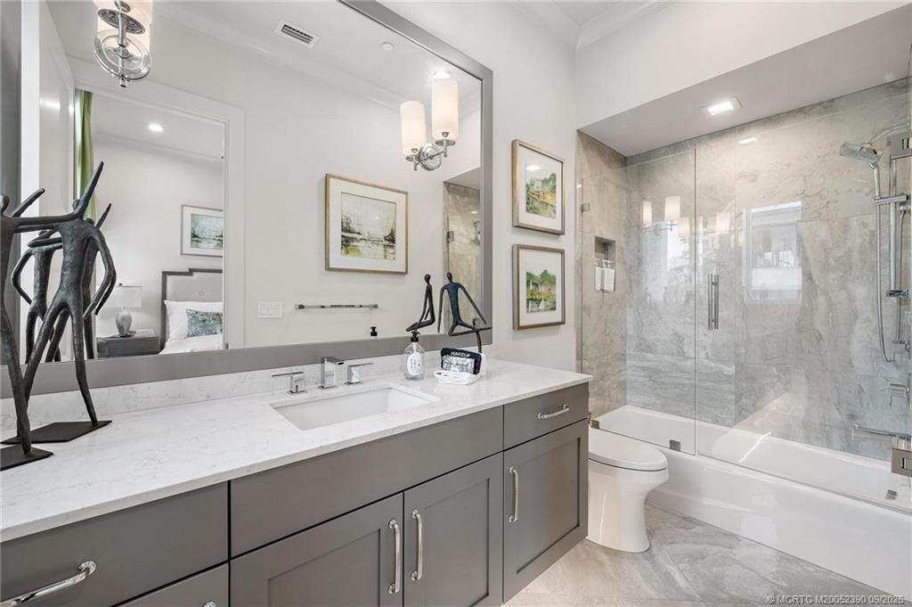 4860 Watersong Way Fort Pierce, FL 34949 - Photo 35 of 45 a bathroom with a bathtub shower sink mirror and toilet