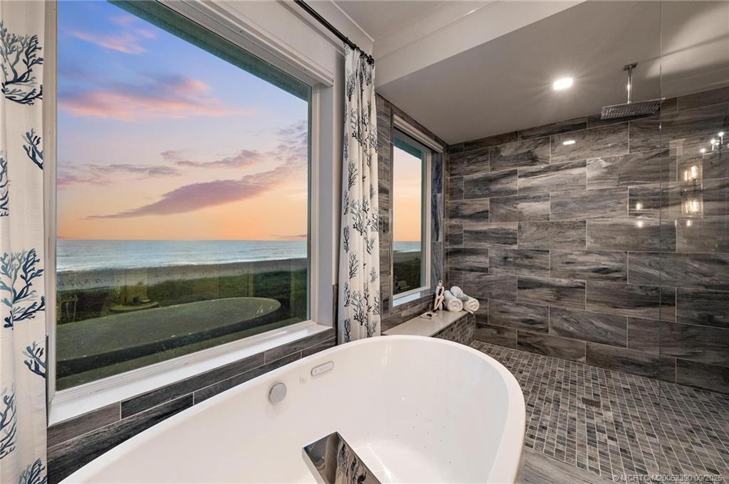 4860 Watersong Way Fort Pierce, FL 34949 - Photo 6 of 45 a bathroom with a bathtub and a shower