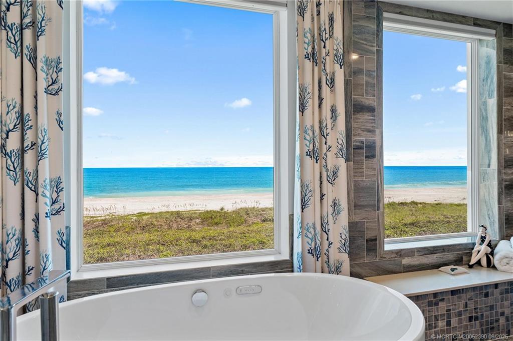 4860 Watersong Way Fort Pierce, FL 34949 - Photo 8 of 45 a bathroom with a bathtub and a shower