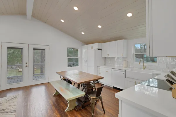 a kitchen with a table chairs and a refrigerator