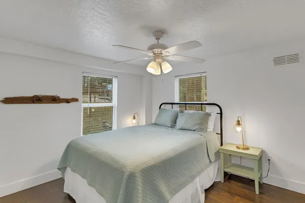 a bedroom with a bed and a chandelier