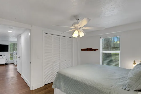 a bedroom with a bed and a chandelier