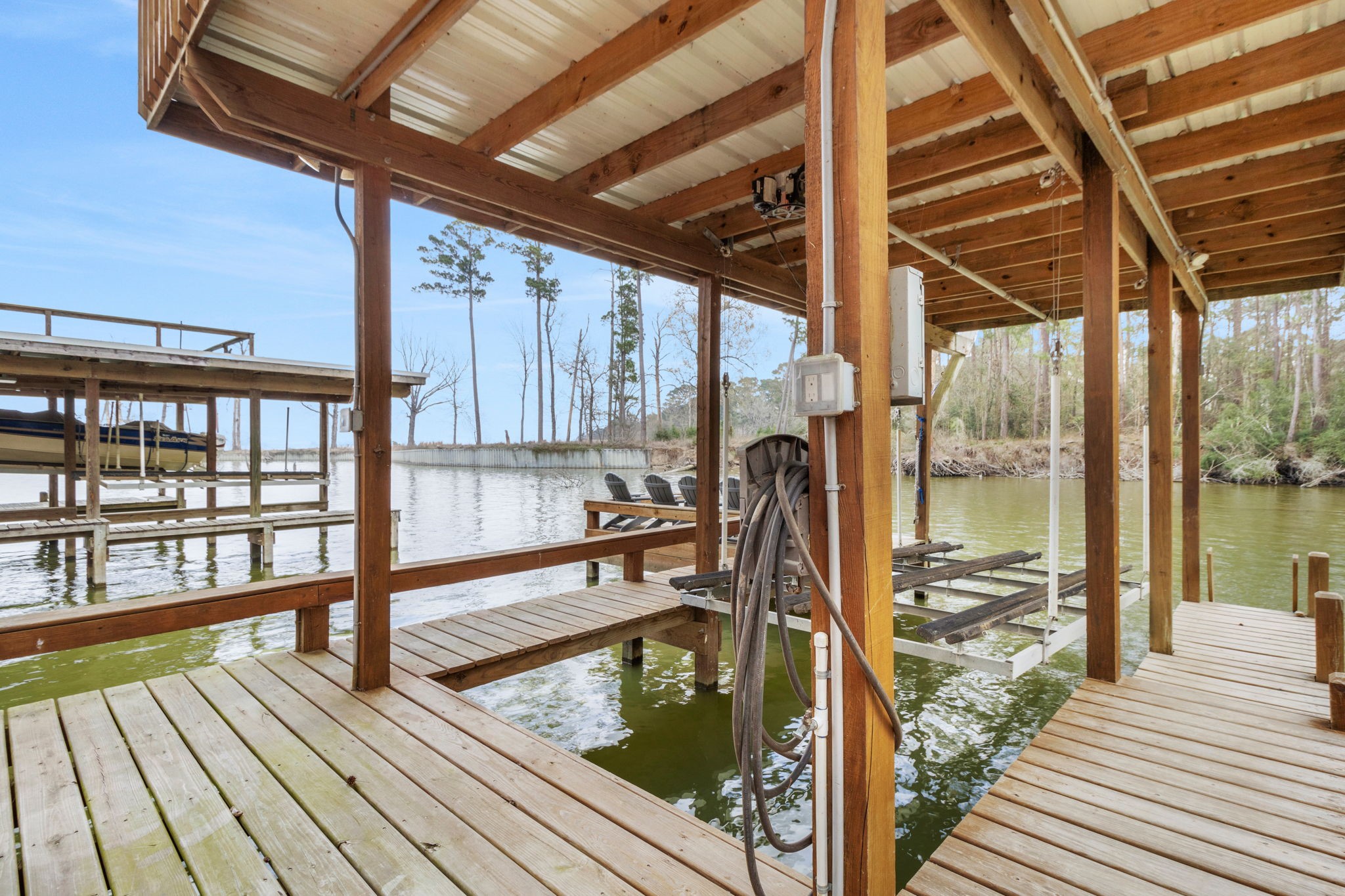 21 Red Bird Lane Coldspring, TX 77331 - Photo 29 of 37 The boat house has a boat lift, seating area and upper deck