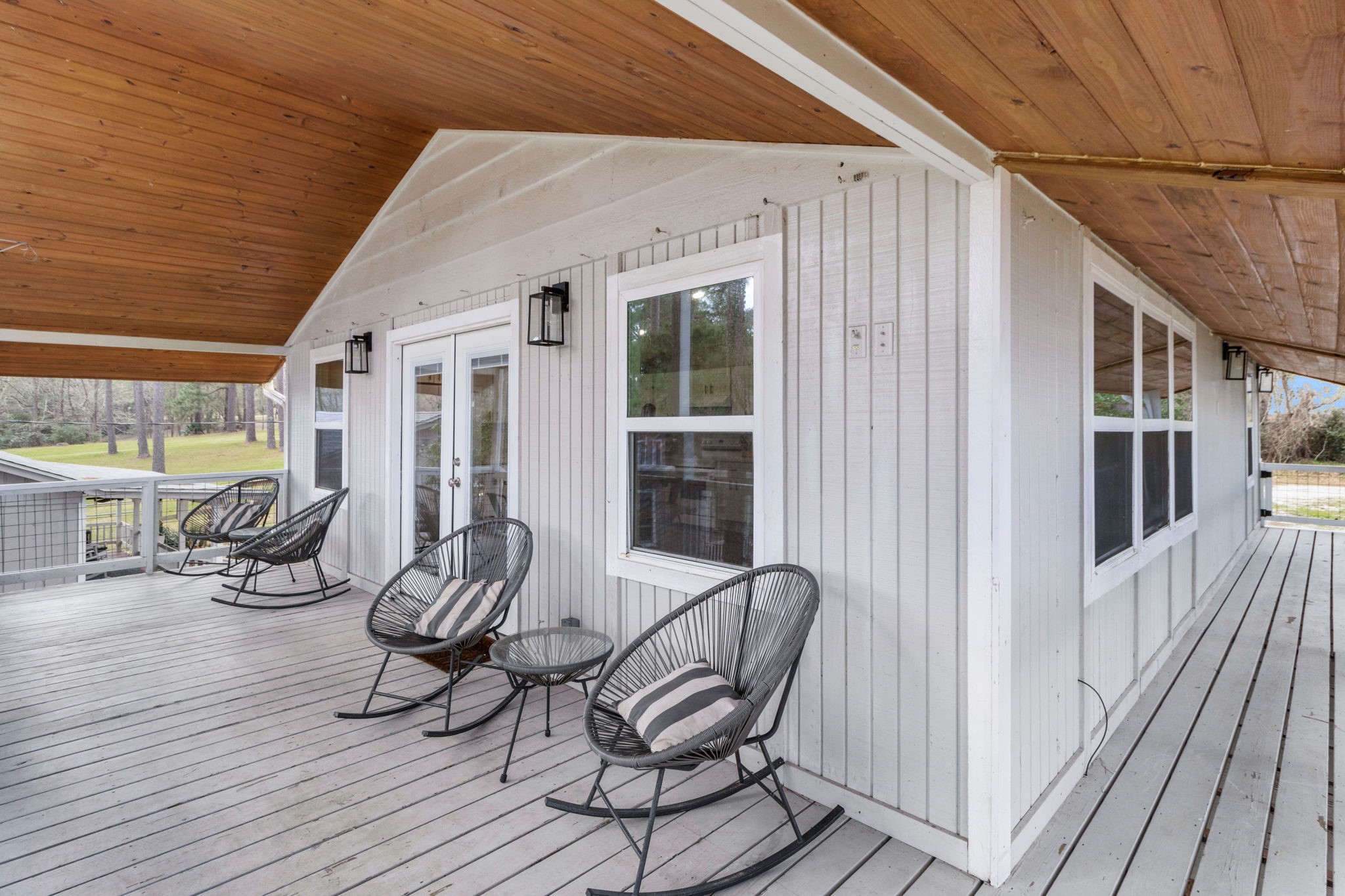 21 Red Bird Lane Coldspring, TX 77331 - Photo 4 of 37 The upper back deck is covered with a vaulted wood accent ceiling