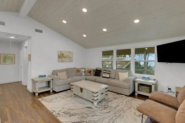 a living room with fireplace furniture and a flat screen tv
