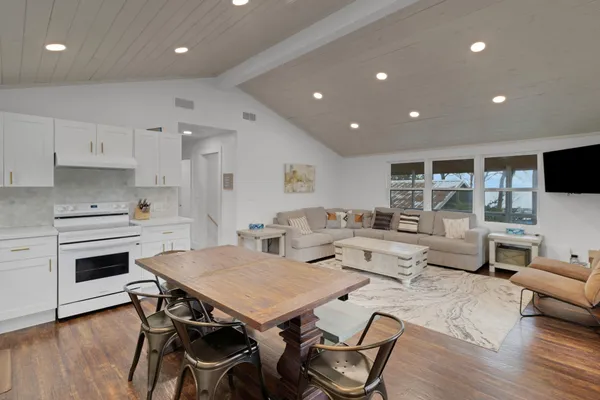 a view of a dining room with furniture wooden floor and a rug