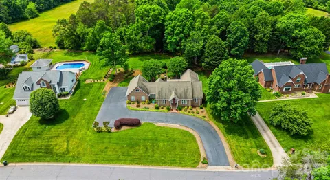 an aerial view of a house with a garden and swimming pool