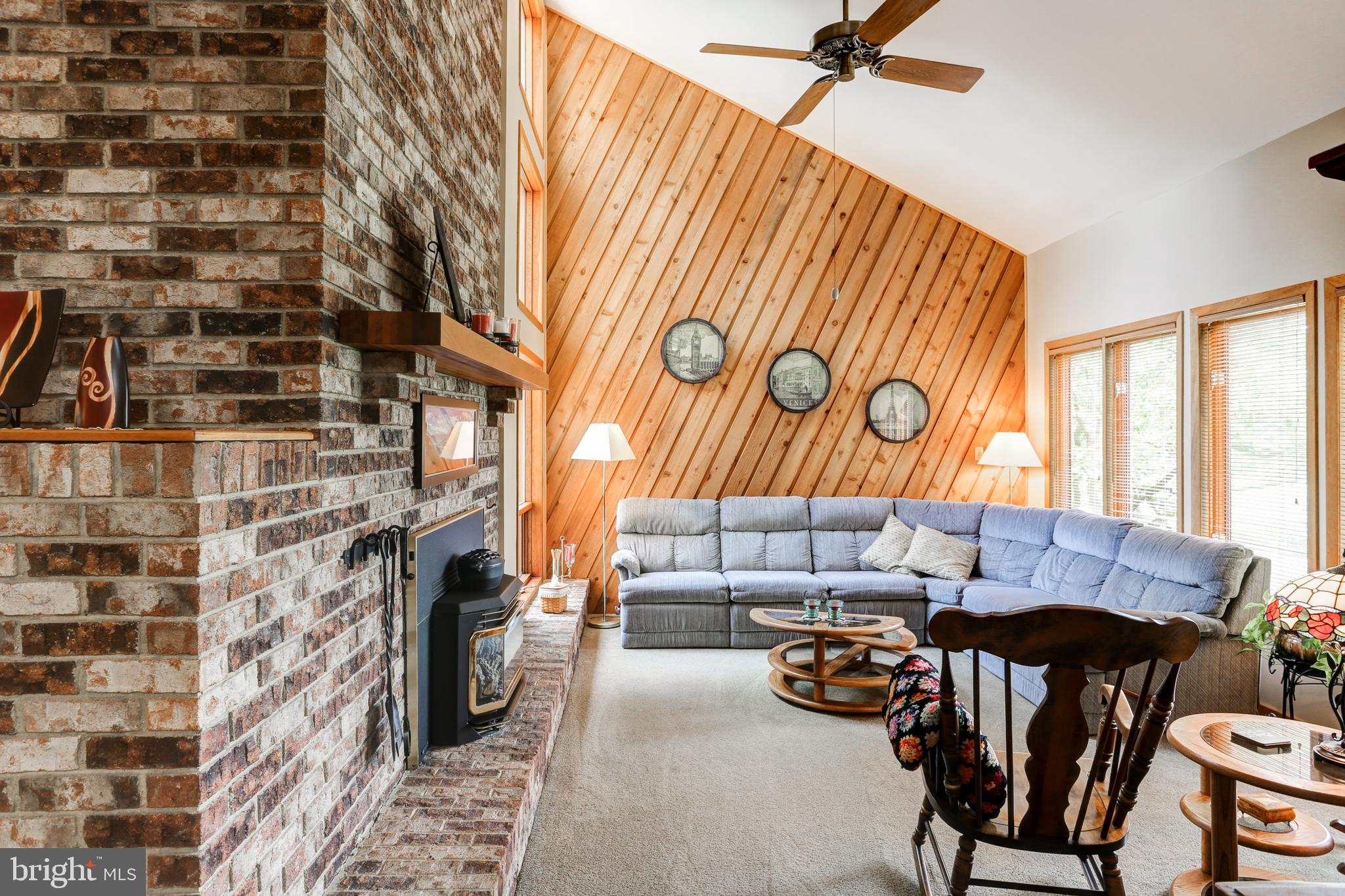 Living room with gas fireplace and vaulted ceiling