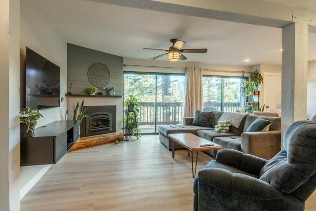 a living room with furniture a fireplace and a flat screen tv