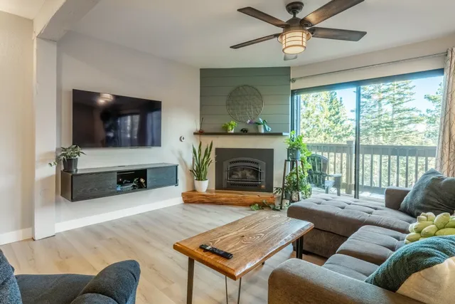 a living room with furniture a flat screen tv and a fireplace
