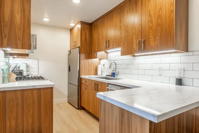 a kitchen with a sink cabinets and appliances