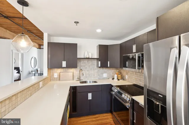 a kitchen with stainless steel appliances a sink stove and refrigerator