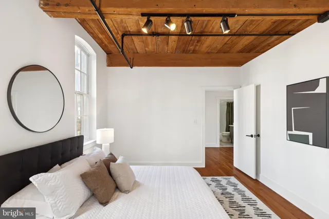 a bedroom with a bed and a mirror