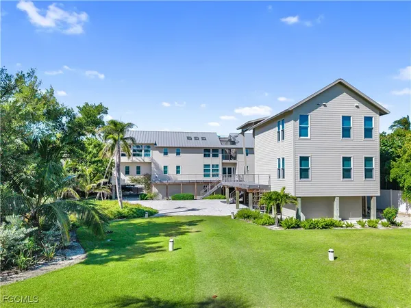 a view of a house with a swimming pool and a yard