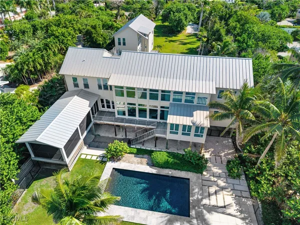 a view of yard with swimming pool and green space