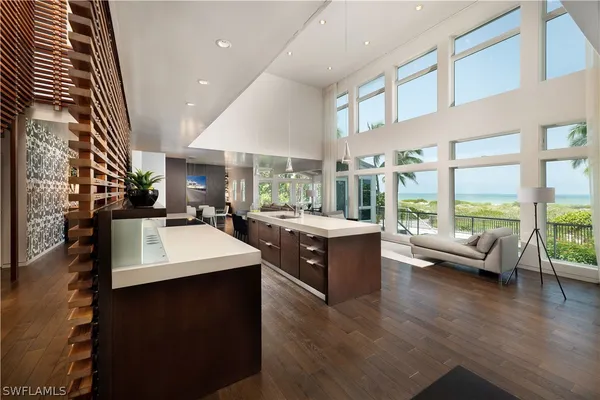 a living room with furniture and a floor to ceiling window