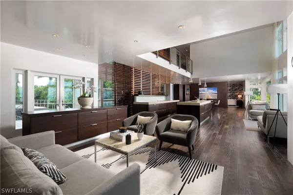 a dining hall with stainless steel appliances kitchen island a stove and a sink