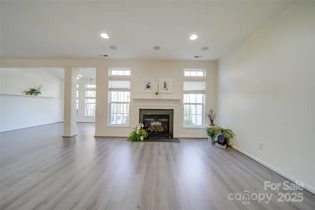 a view of an empty room with window and fire place