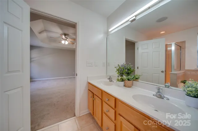 a bathroom with a double vanity sink and a mirror
