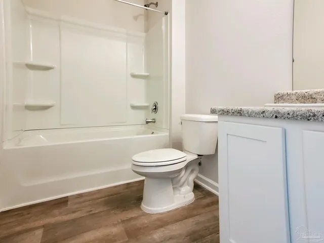 a bathroom with a toilet sink and shower
