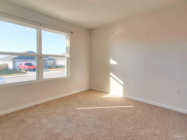 an empty room with windows and entrance