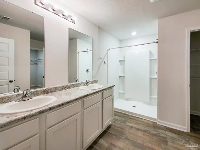 a bathroom with a granite countertop sink mirror and double