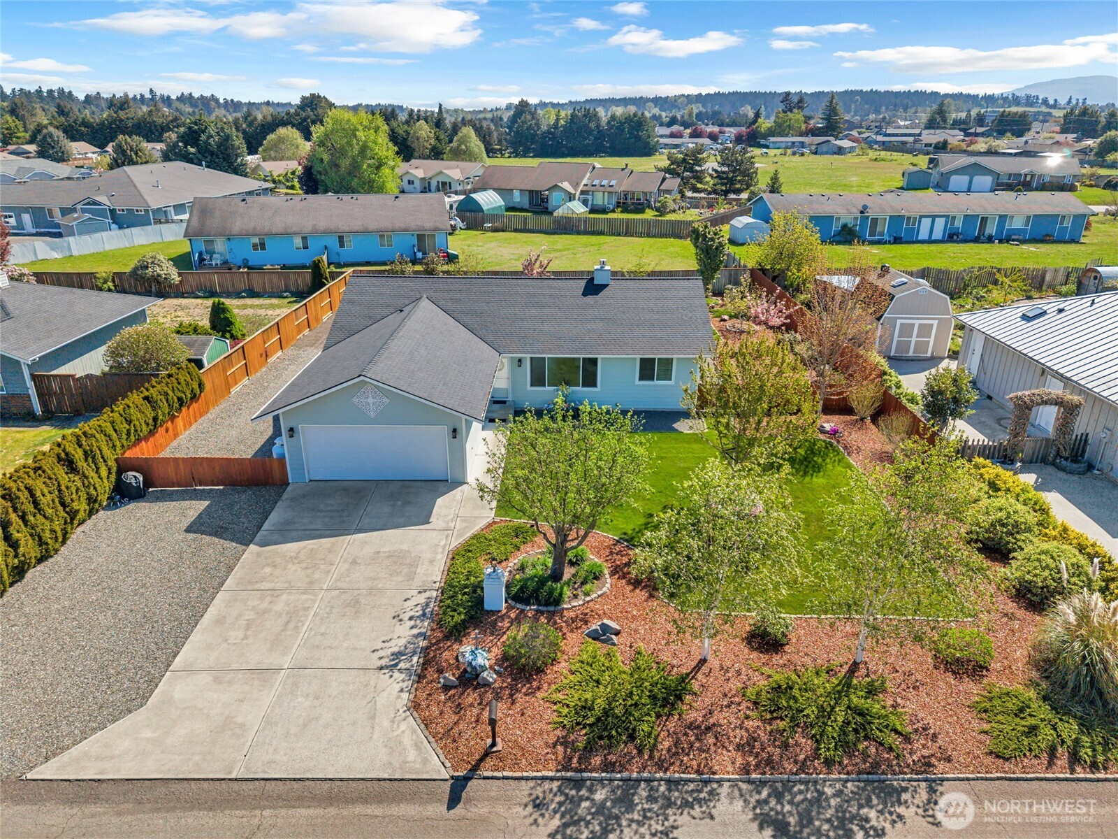 an aerial view of residential houses with outdoor space and swimming pool