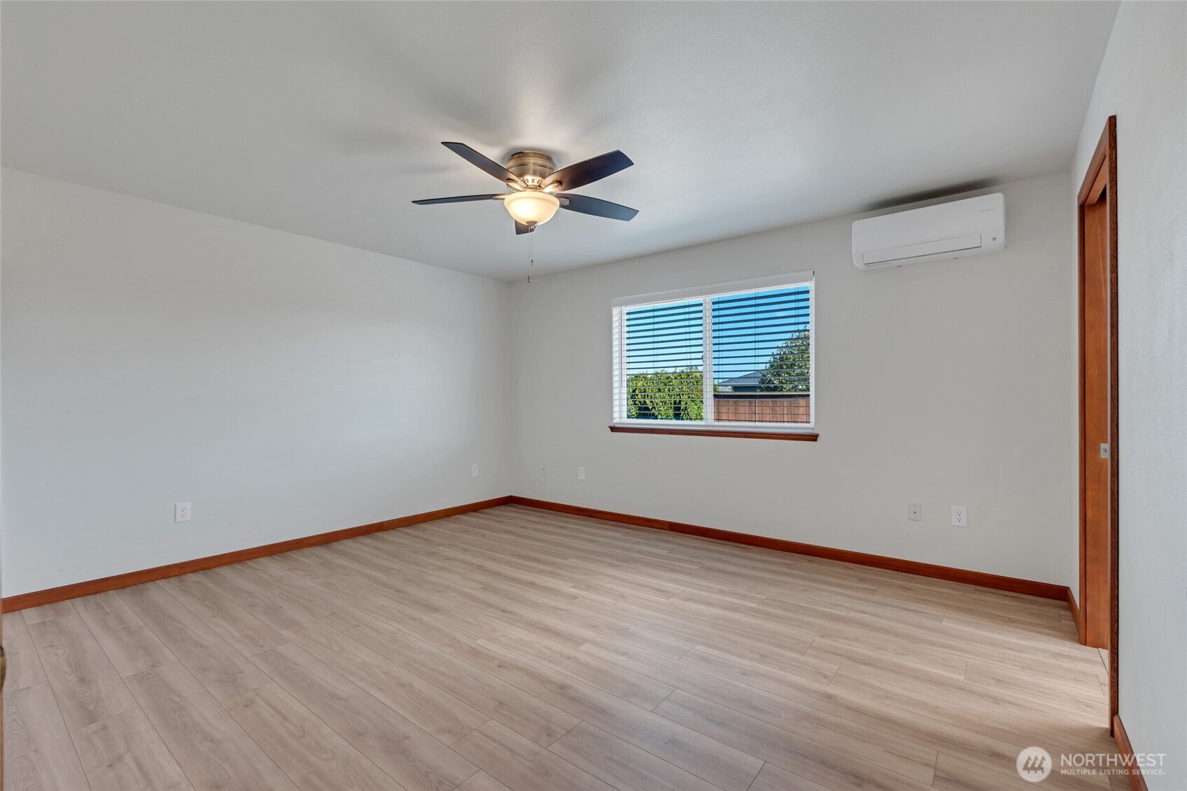 161 Duke Drive Sequim, WA 98382 - Photo 12 of 40 a view of an empty room with a window and wooden floor