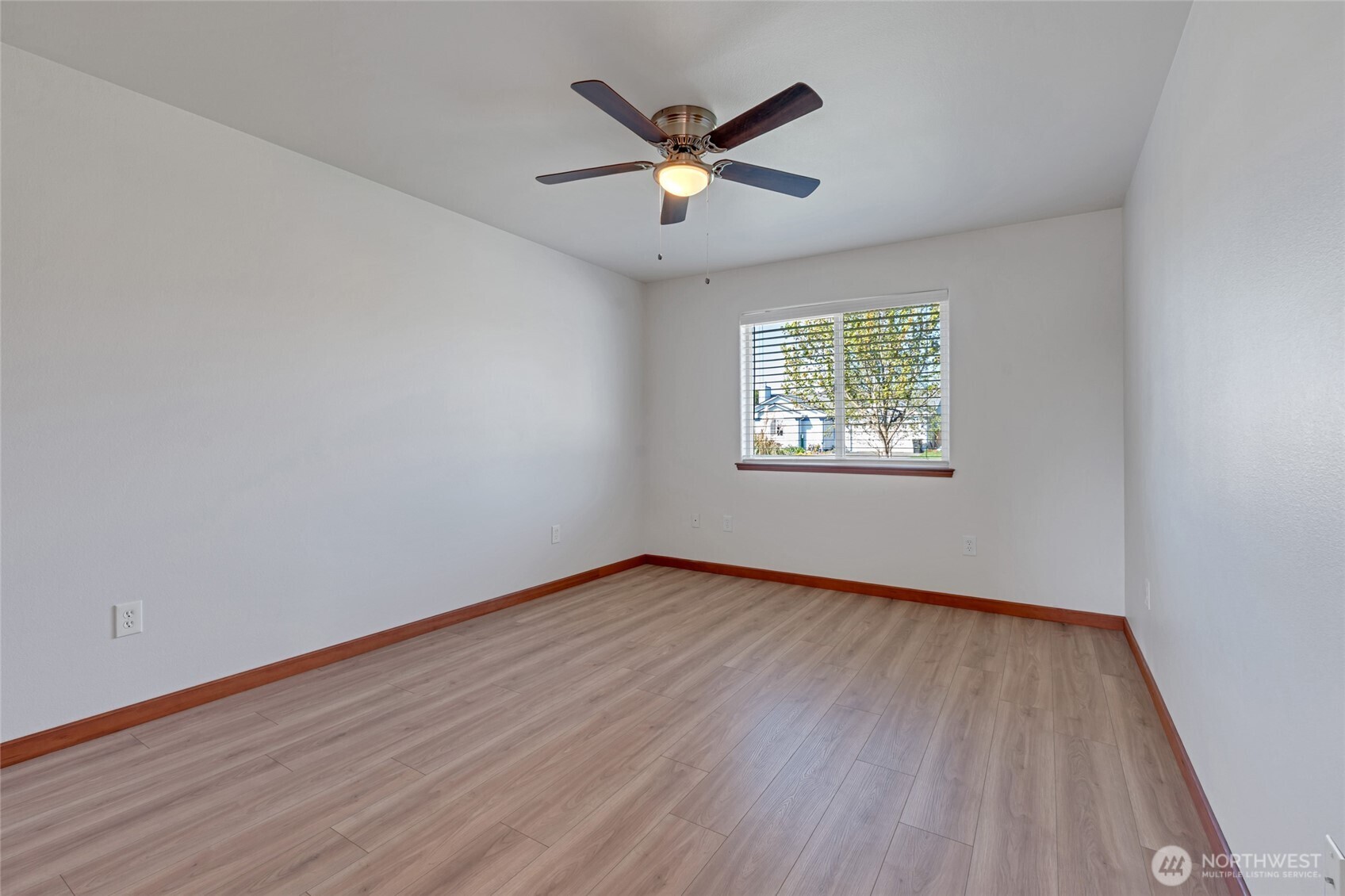 161 Duke Drive Sequim, WA 98382 - Photo 19 of 40 an empty room with wooden floor chandelier fan and windows