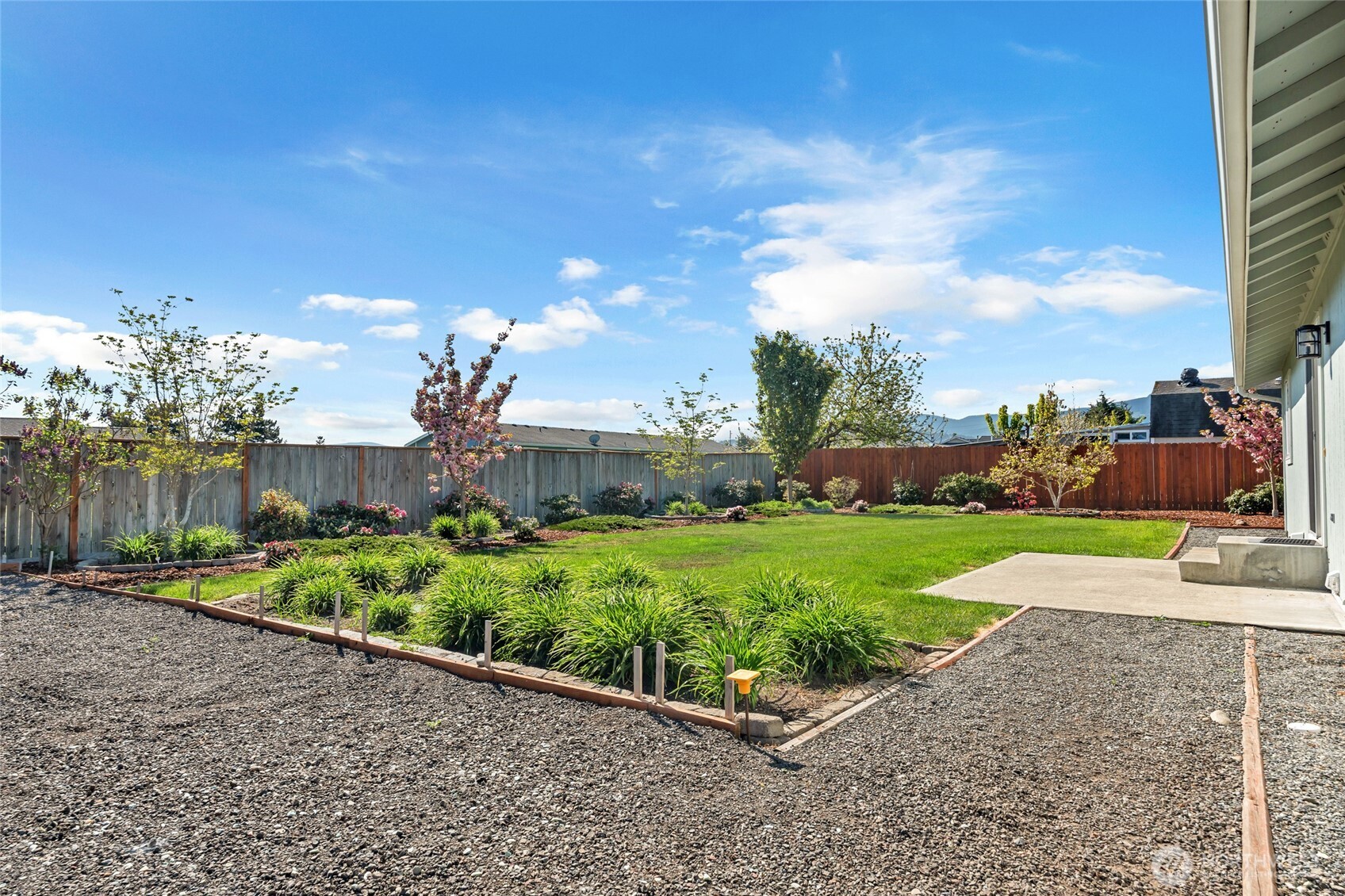 161 Duke Drive Sequim, WA 98382 - Photo 29 of 40 a view of a garden with a building in the background