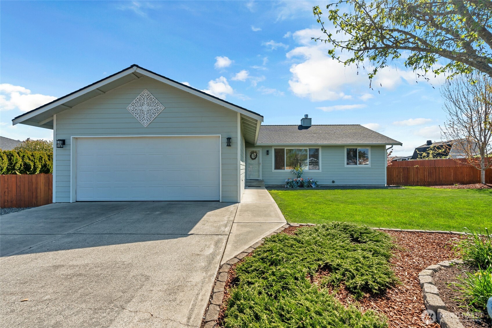 161 Duke Drive Sequim, WA 98382 - Photo 3 of 40 a front view of a house with a yard and garage
