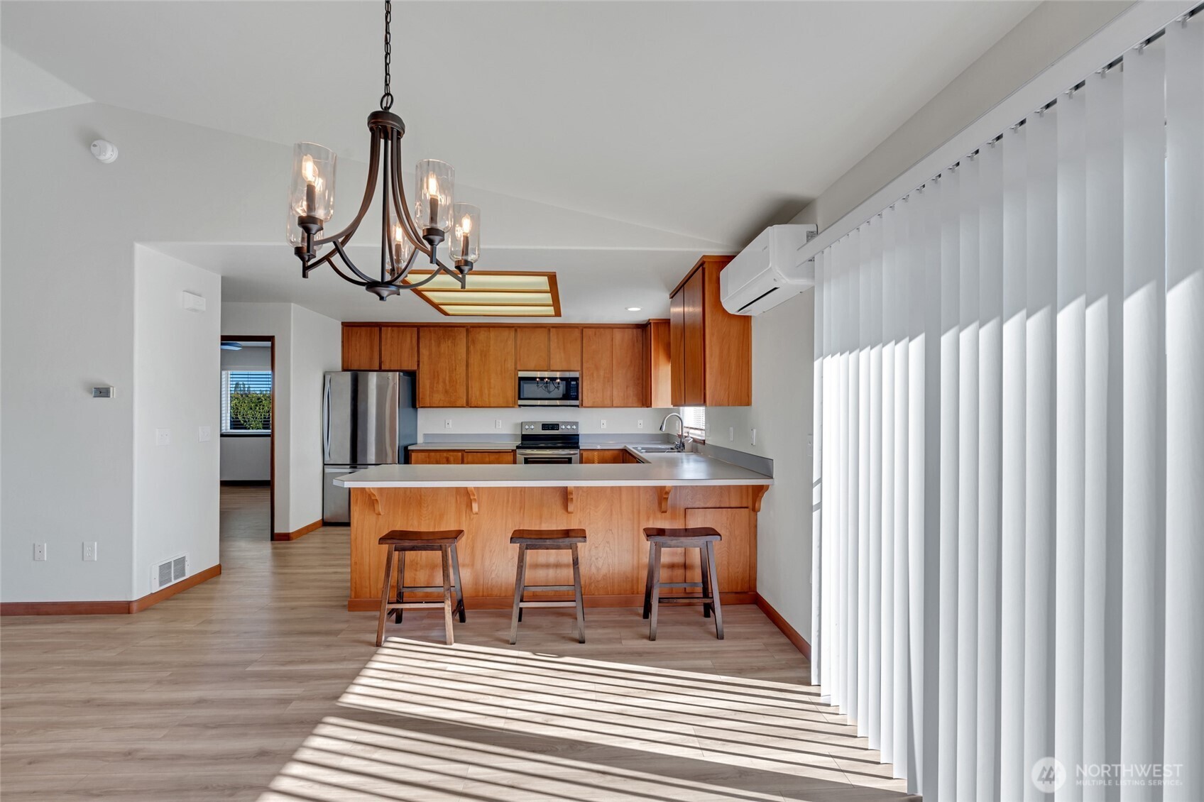 161 Duke Drive Sequim, WA 98382 - Photo 8 of 40 a dining room with wooden floor a chandelier a wooden table and chairs
