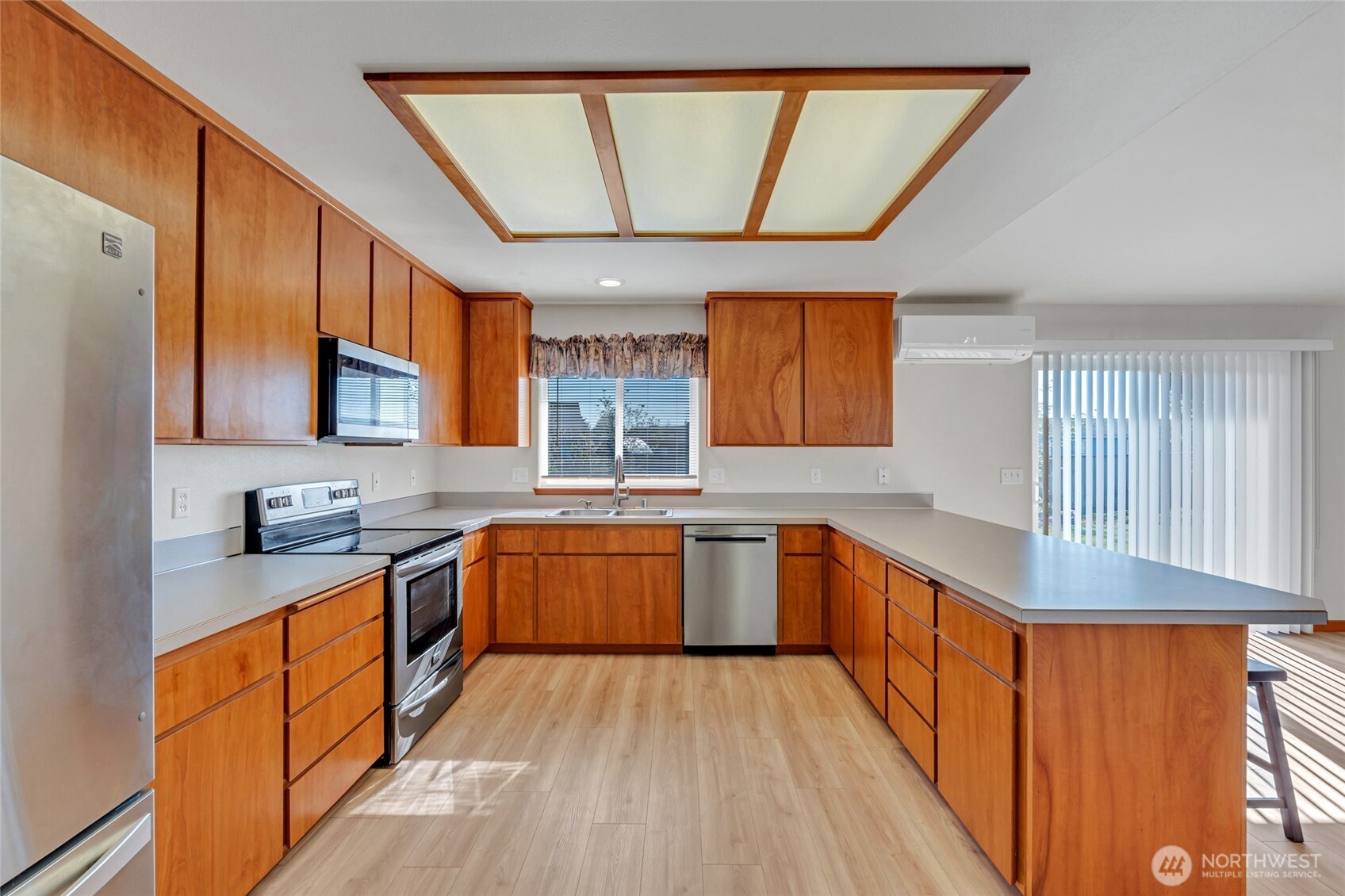 161 Duke Drive Sequim, WA 98382 - Photo 9 of 40 a kitchen with stainless steel appliances granite countertop wooden cabinets a sink and dishwasher a stove with wooden floor