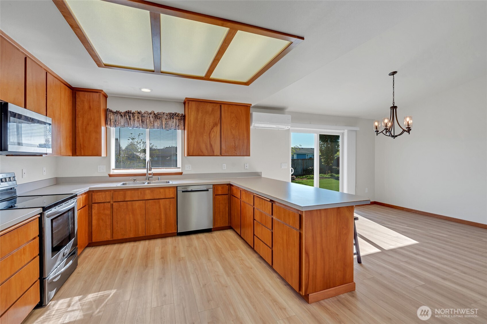 161 Duke Drive Sequim, WA 98382 - Photo 10 of 40 a kitchen with stainless steel appliances granite countertop wooden floors and sink
